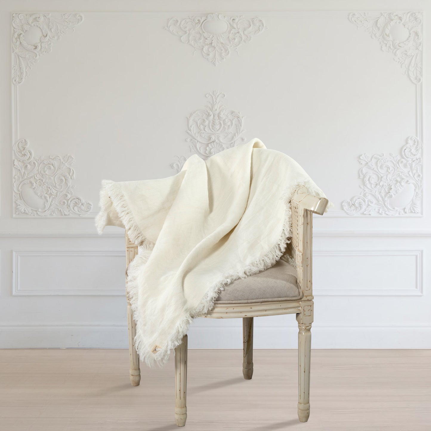 a white Abbey throw blanket on a chair