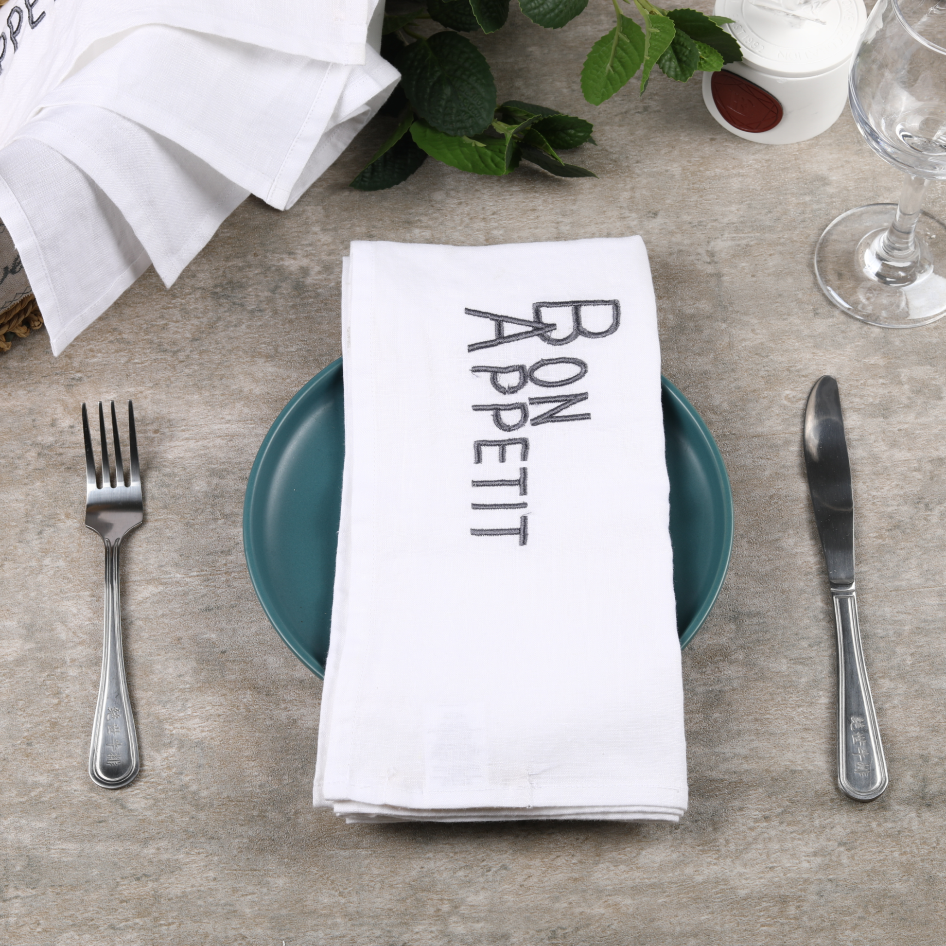 a Plate With a Bon Appetit Napkin And Fork On It